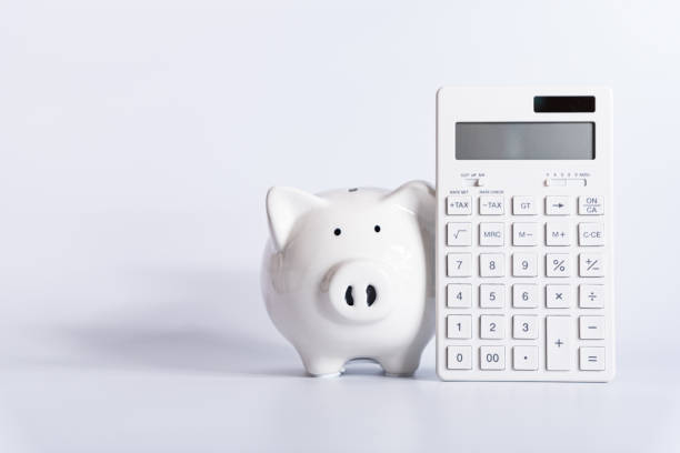 piggy bank with calculator stock photo
