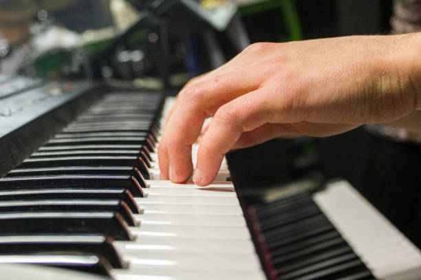 istock Hands playing keyboard or piano, macro with fingers making the chord 1170055536