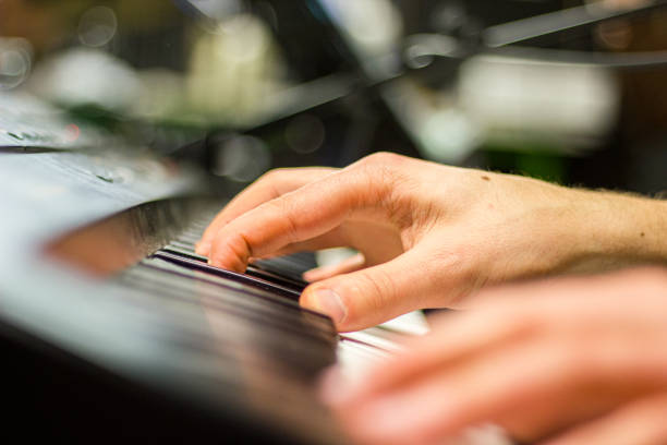 istock Hands playing keyboard or piano, macro with fingers making the chord 1170055751