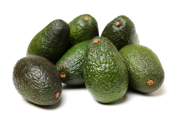 авокадо на белом фоне - avocado brown стоковые фото и изображения