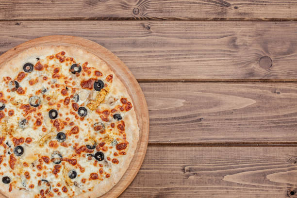 istock Pizza with Mozzarella cheese, chicken, olives, Spices . Italian pizza 1170068617