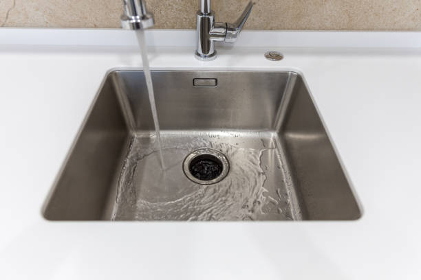 istock Stainless kitchen sink with food waste disposal in modern home 1170068828