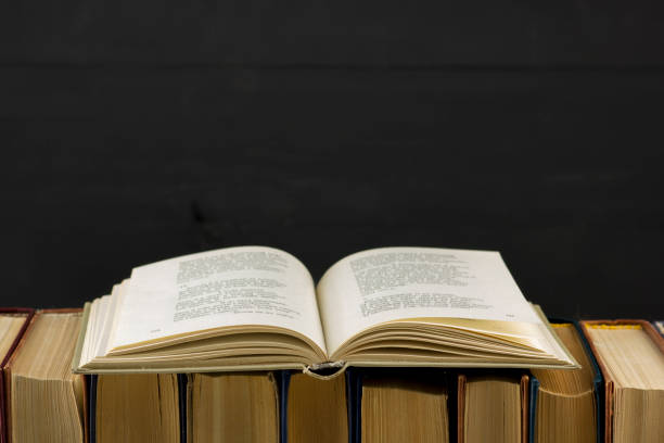 istock Open book, hardback books on wooden table. Back to school. Copy space 1170069025