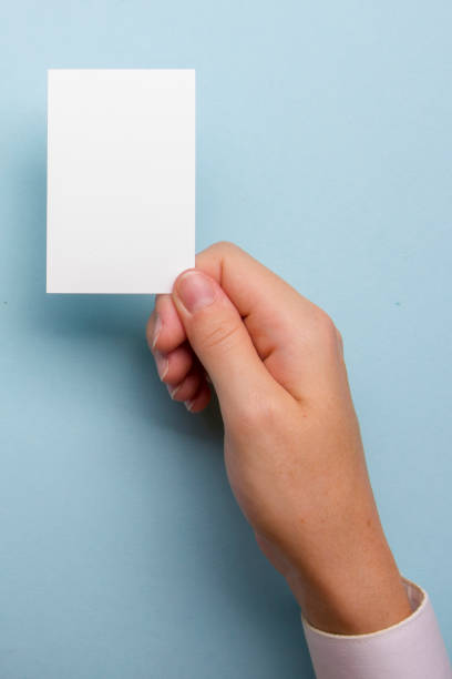 istock Hand holding white business card on white background 1170069223