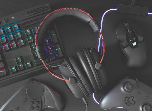 istock gamer work space concept, top view a gaming gear, mouse, keyboard, joystick, headset, mobile joystick, in ear headphone and mouse pad on black table background. 1170073825