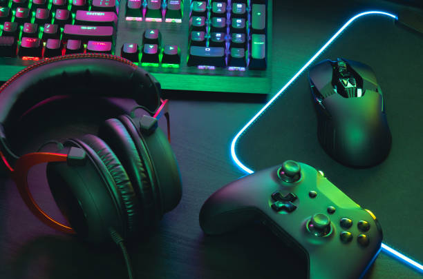istock gamer work space concept, top view a gaming gear, mouse, keyboard, joystick, headset, mobile joystick, in ear headphone and mouse pad on black table background. 1170073826