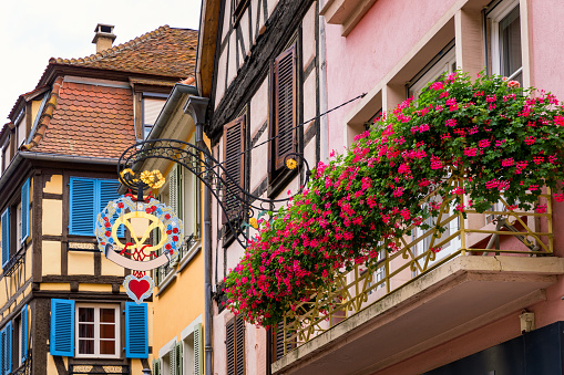 Colmar, France - July 27, 2018: Old town of Colmar, Alsace, France. View with colorful buildings, canal and flowers. Colmar, France. Petite Venice, water canal and traditional half timbered houses.