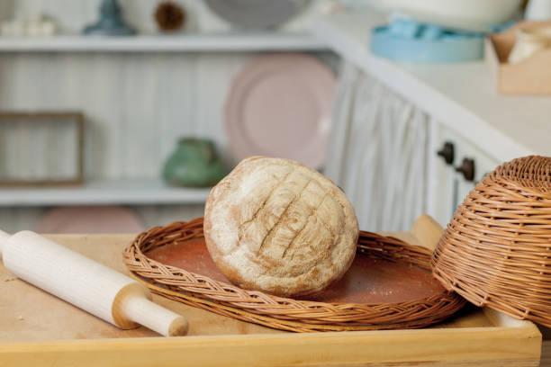 istock Breads near a wicker basket on a table in a rustic kitchen. Composition in kitchen at the photo studio 1170075102