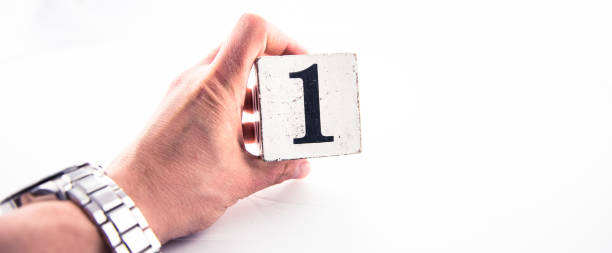 istock A hand holding digit number 1 (one) on white background 1170075276
