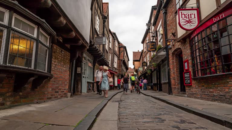 Time-lapse: Tourist Pedestrian Commuter Crowd at York shamble shopping area in York England Uk.