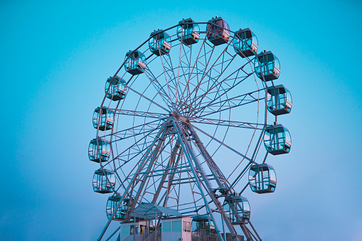 Ferris wheel against the background of the summer sky in the daytime