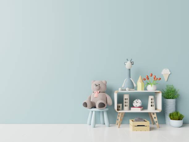 istock Teddy bear and rabbit doll in the children's room on blue wall background. 1170077264