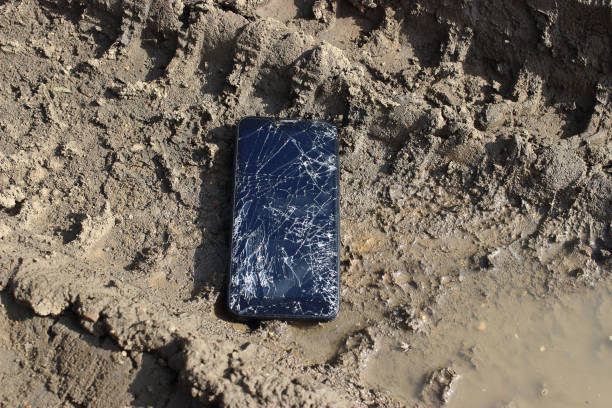istock The smartphone with a broken display lies in a dirt, cracks and damage to the device. 1170079785