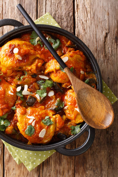 istock Moroccan Chicken with Eggplant, Tomatoes, and Almonds closeup on a plate. Vertical top view 1170082272