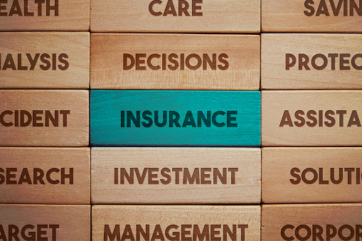 Insurance related words on wooden blocks