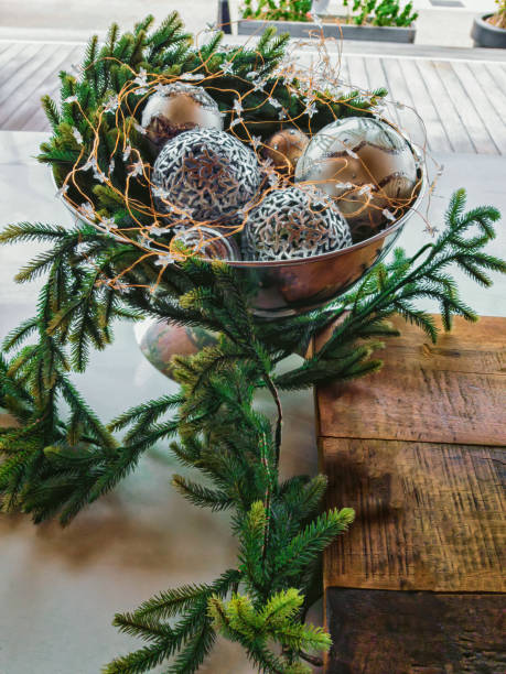 Christmas still life. Vase with Christmas balls and pine branches stock photo