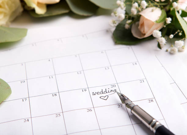 istock Wedding calendar with pen writing text on planning date 1170086229