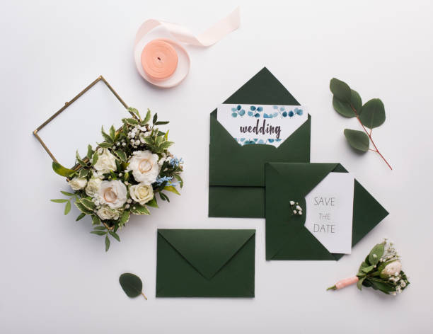 istock Stylish dark green envelopes with accessories on white 1170086261