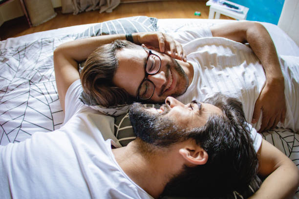 gay couple in bed - sensuality lifestyles cheerful comfortable imagens e fotografias de stock