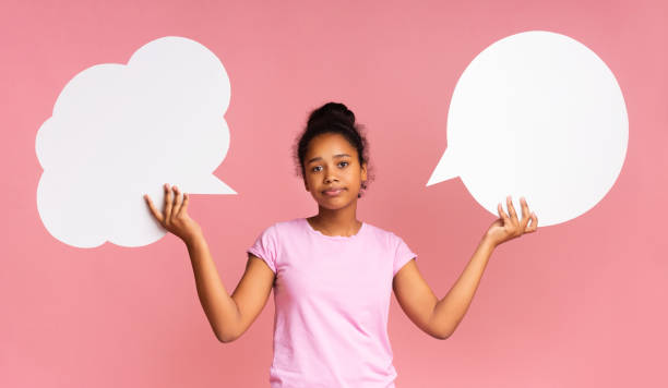 istock Teen girl having complex choice holding two speech bubbles 1170089278