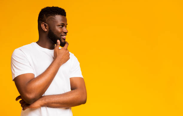 istock Young african american man touching his chin thoughtfully 1170089290