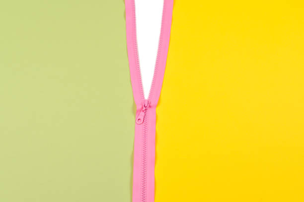 Pink zipper splits green and yellow background isolated.