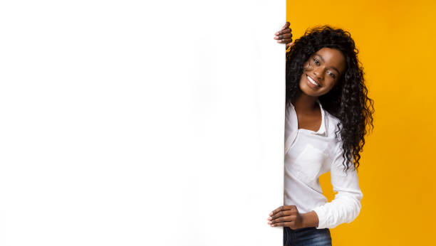 istock Afro woman staying next to blank board 1170089567
