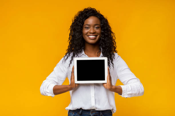 istock Afro smiling woman demonstrating blank digital tablet screen 1170090692