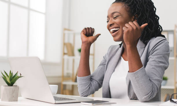 Excited Afro Businesswoman Celebrating Success At Work
