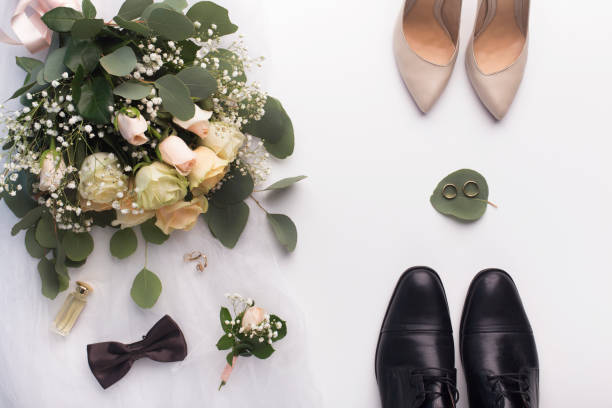 istock Wedding bouquet, her and his shoes on white background 1170090728