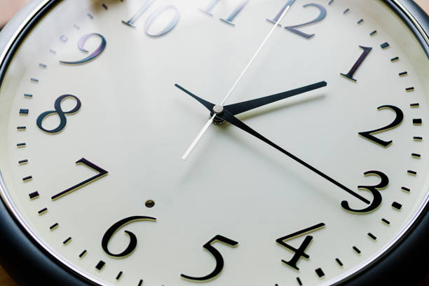 istock Close up of a clock isolated on dark background 1170091294