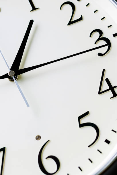 istock Close up of a clock isolated on dark background 1170091815