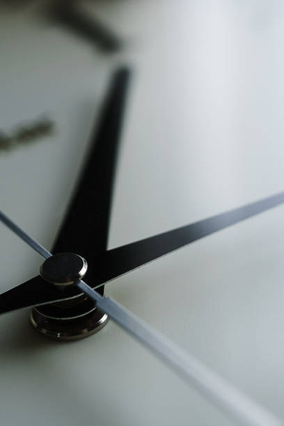 istock Close up of a clock isolated on dark background 1170091850