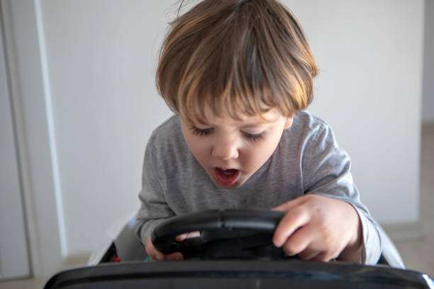 istock Little boy driving toy car 1170091993