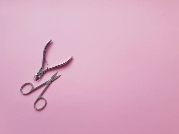 istock manicure scissors and tweezers on a pink background, processing and nail care, flatlay 1170092322
