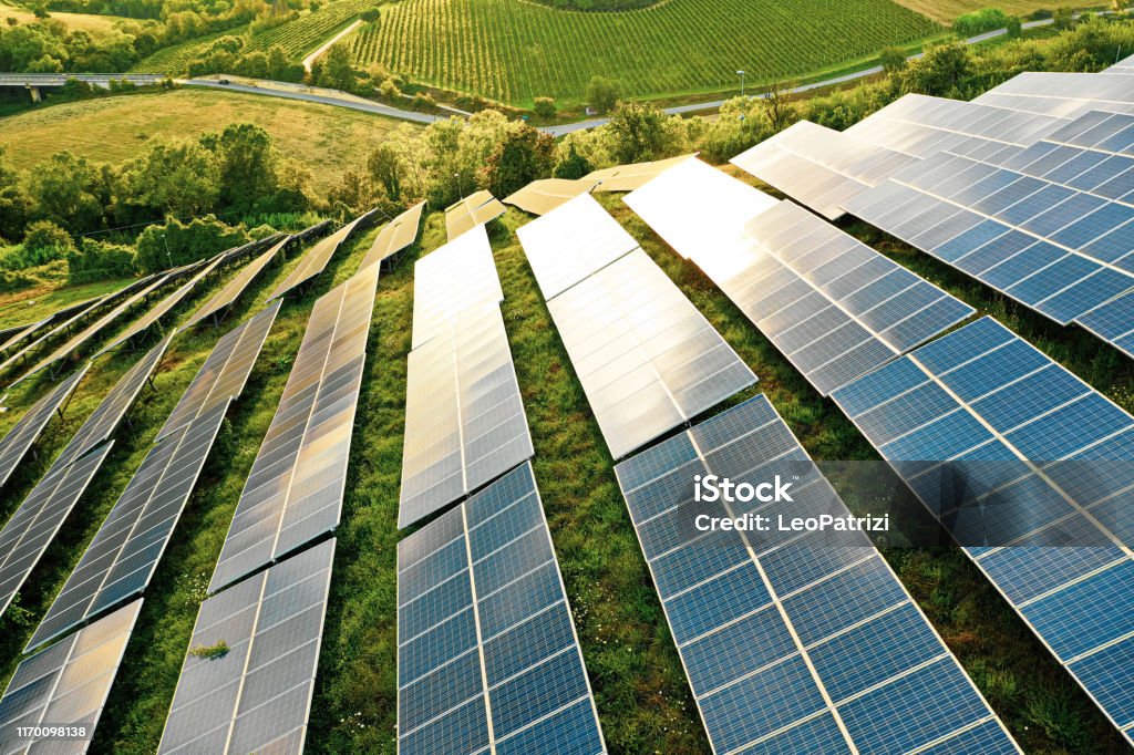 Campos de paneles solares en las colinas verdes - Foto de stock de Panel Solar libre de derechos