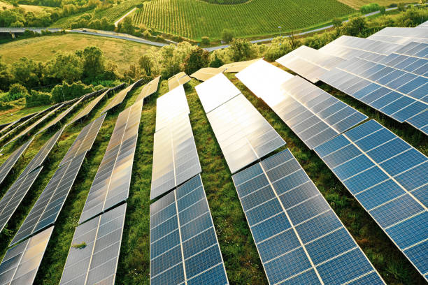 Solar panels fields on the green hills stock photo