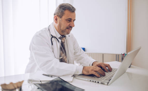 istock the doctor uses a laptop 1170099262