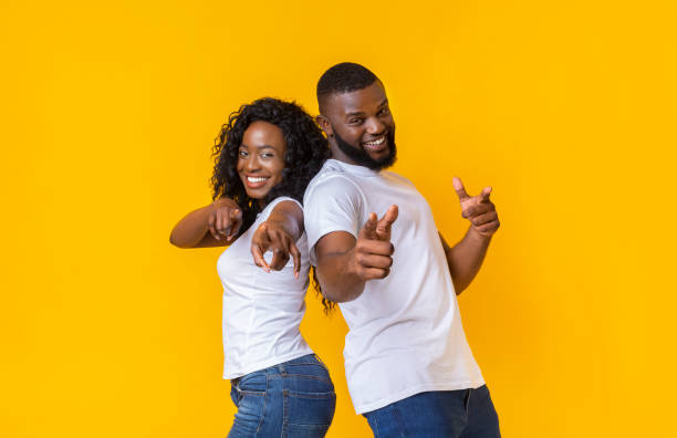 istock Joyful young black couple pointing fingers at camera 1170099438