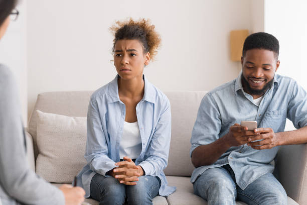 istock Afro Husband Playing Phone Visiting Couples Therapy With Wife 1170099630