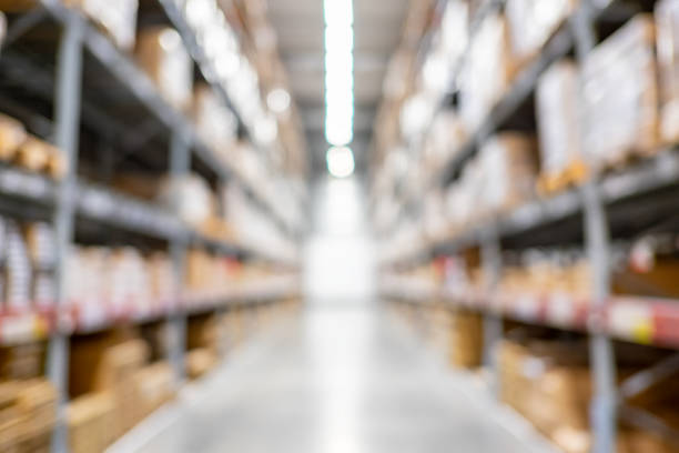 istock blur background of storage warehouse with boxes packaging on shelf 1170100161