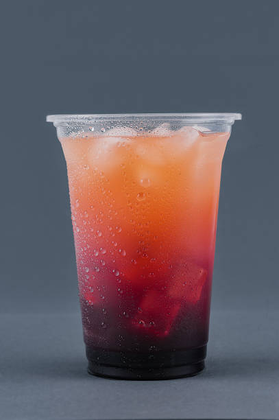 istock Cold drink with syrup and ice cubes on a gray background 1170101073