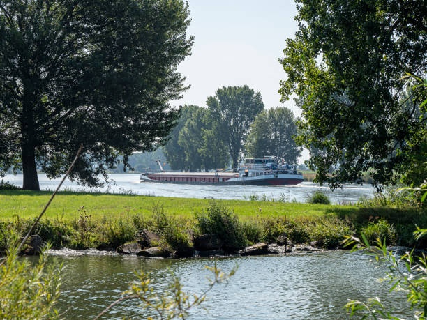 Inland waterway vessel upstream the Meuse at Mook