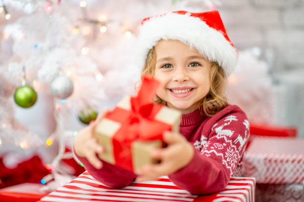 Christmas kids! Beautiful children enjoying Christmas morning. surgical light stock pictures, royalty-free photos & images