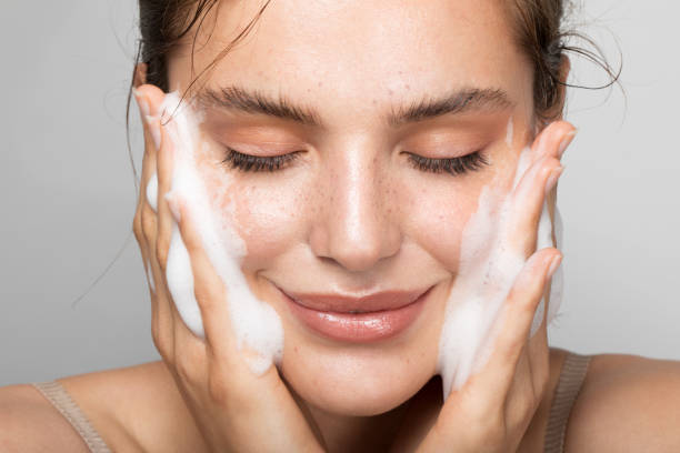Keep your skin clean Close up studio shot of a beautiful woman with perfect skin, while she cleaning her face foam material photos stock pictures, royalty-free photos & images