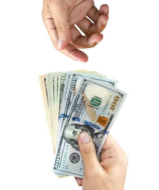 One hand holding US dollar banknote for giving and blank one hand wait receiving it. Payment concepts. One hand holding US dollar banknote for giving and blank one hand wait receiving it. Payment concepts. giving money stock pictures, royalty-free photos & images