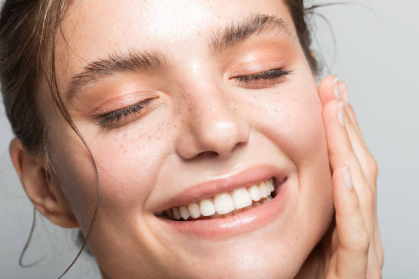 Young woman portrait Close up studio shot of a beautiful woman with perfect skin, she touching her face caucasian human face women freshness stock pictures, royalty-free photos & images