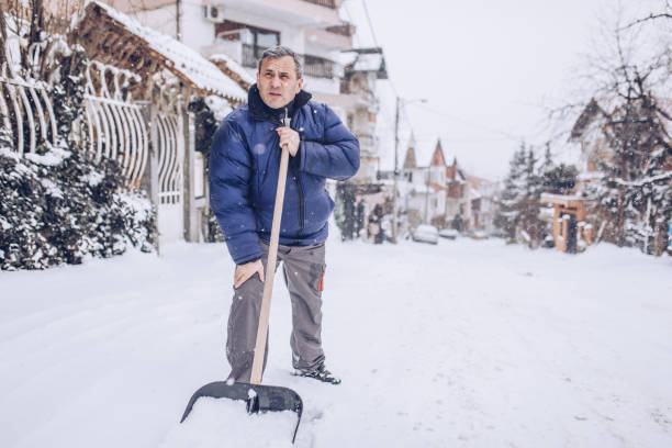 istock Man cleaning snow on the street 1170106082