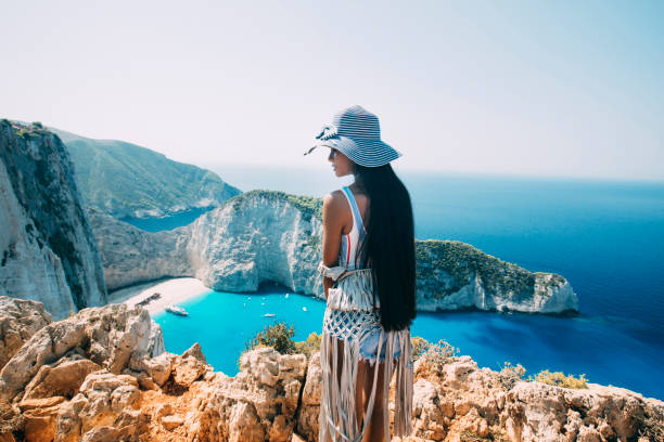 istock Woman walking and looking at sea 1170111510