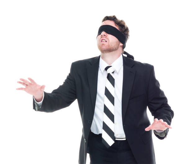 istock Handsome businessman wearing a black suit - is wearing a blindfold 1170111692